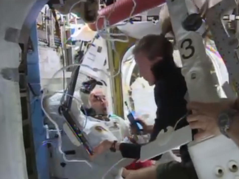 In this Tuesday, July 16, 2013 image from video made available by NASA, astronaut Karen Nyberg assists astronaut Luca Parmitano remove his space suit after an aborted spacewalk aboard the International Space Station. A final report issued Wedesday, Feb. 26, 2014 by NASA says it could have prevented the near-drowning of the spacewalking astronaut. According to the report, Parmitano's helmet had also leaked one week earlier at the end of his first spacewalk. The report says the space station team misdiagnosed the first failure and should have delayed the second spacewalk until the problem was understood. (AP Photo/NASA)