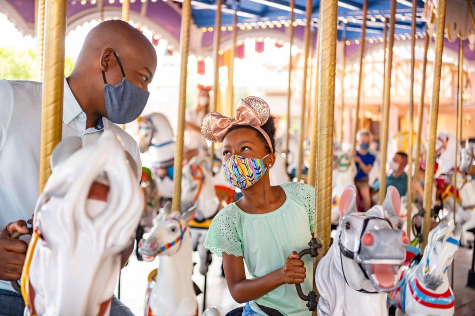 Visitors ride King Arthur Carrousel at Disneyland park on June 12, 2020 in Anaheim, California. Disneyland plans to reopen on April 30, 2021.