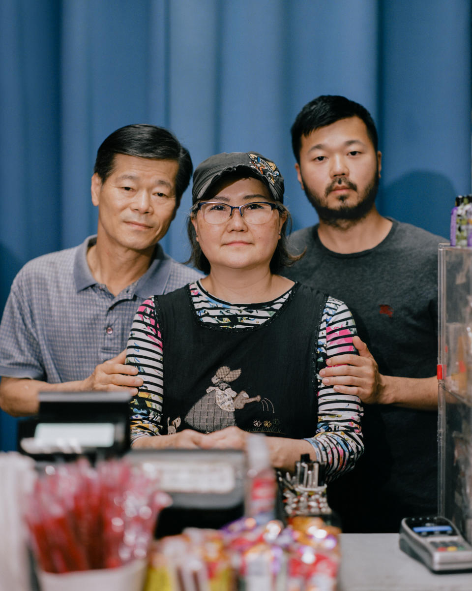 <strong>'I STILL WISH FOR A BETTER LIFE.' </strong>Mun Sung, left, and Joyce Sung, center, stand with their 35-year-old son Mark Sung, right, in the family’s Charlotte, N.C., convenience store on May 29. The elder Sungs watched helplessly on March 30 as a man smashed through glass with a metal pole, ripped down racks and hurled racial slurs at them inside the store they’ve owned for two decades. Despite facing racism at work on a daily basis since the pandemic began—even growing hardened to the hatred month after month—Mun never expected his family would fall victim to such violence. “I feel so terribly bad,” the 65-year-old says, “because how can people do that to us?” Less than two months later, it happened again. On May 25, after being told he did not have enough money for cigarettes, a customer shouted racial slurs as he pummeled a sheet of plexiglass at the checkout counter until it shattered on Joyce, 63, bruising her forehead. “Knowing that we’re going to get cursed out every day while we’re getting ready for work,” she says, pausing to think, “we don’t know what words to use.” The family has few other options. The pandemic drove down sales at the store by about 45%—and all their employees quit over safety concerns—so the Sungs say they don’t have the luxury to stop working. Instead, they clock in 13-hour days, seven days a week, and have developed a routine for responding to hate: call the police, assess the damage, file an insurance claim, then go back to work. It’s not the life Mun imagined for himself or his family when he left South Korea for the U.S. in 1983. But he and Joyce keep going, in large part to have some money to leave for Mark’s two toddlers, their only grandchildren. “The first time I came to the United States, I had big dreams and high hopes,” Mun says. “I didn’t make it, but I still wish for a better life.”<span class="copyright">Emanuel Hahn for TIME</span>