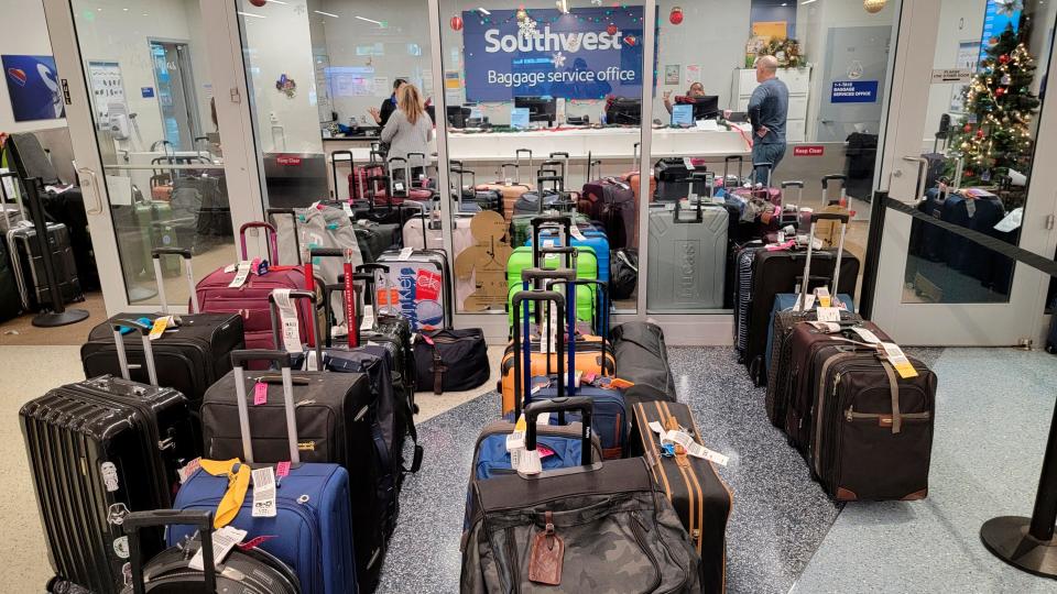 Southwest Airlines baggage service office staff assist stranded passengers with their luggage at the Southwest terminal at the Los Angeles International Airport, on Tuesday, Dec. 27, 2022.