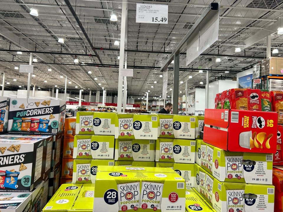 boxes of skinny pop popcorn bags on the shelves at costco
