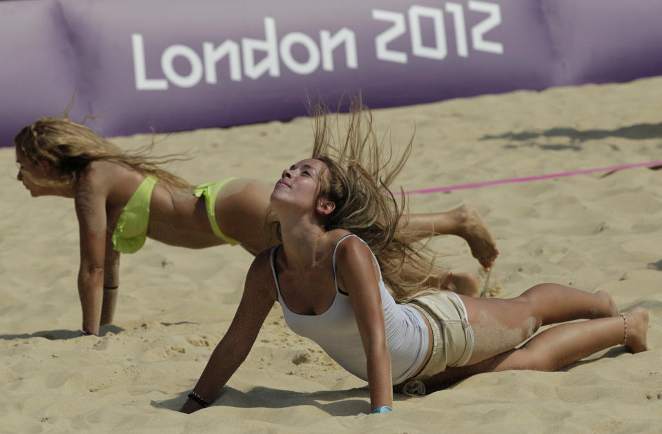 Dancers rehearse prior to the start of the Beach Volleyball competition at the 2012 Summer Olympics, Wednesday, July 25, 2012, in London. (AP Photo/Dave Martin)