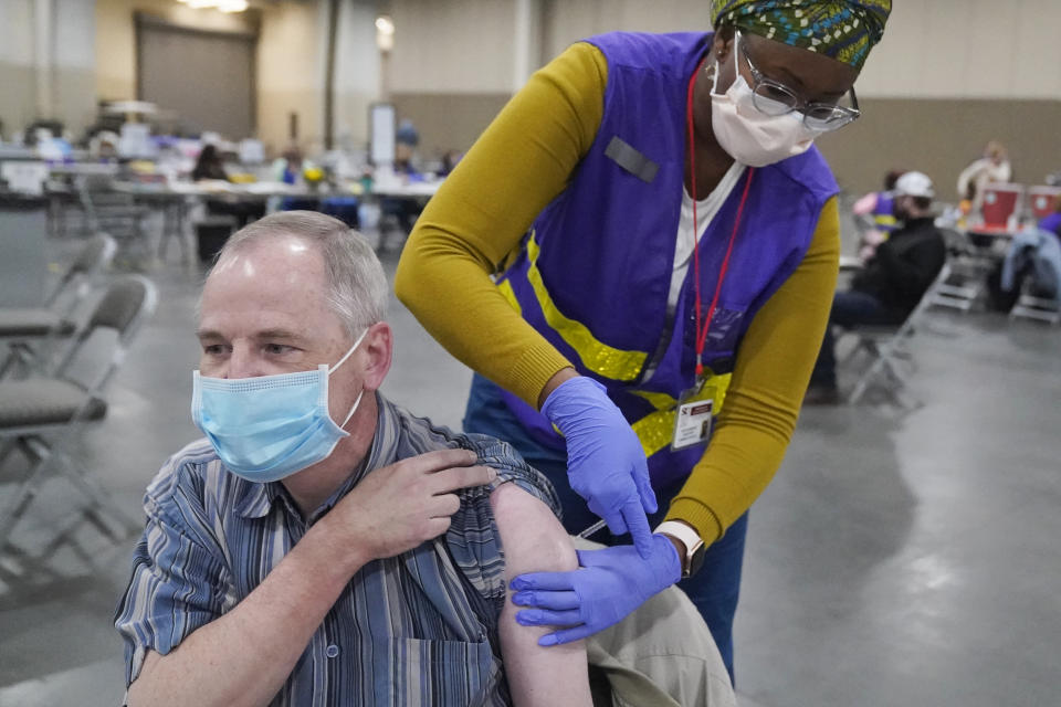 Garry Garff receives his Pfizer COVID-19 vaccination Wednesday, March 10, 2021, in Sandy, Utah. All people in Utah age 18 and over will be eligible to receive a COVID-19 vaccine on April 1, the governor's office announced Wednesday, March 10, 2021. State officials expect to have 1.5 million doses by April 10, when Utah's statewide mask order will be lifted, said Jennifer Napier-Pearce, spokeswoman for Gov. Spencer Cox. (AP Photo/Rick Bowmer)