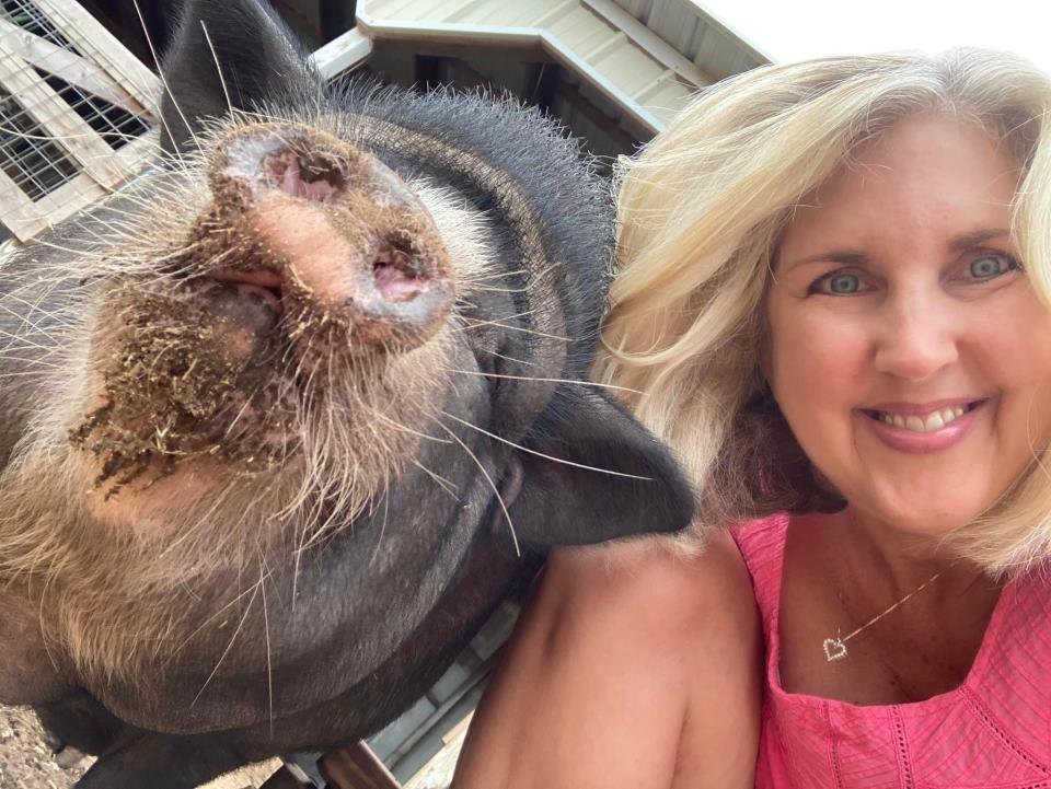 Courtenay Rudzinski smiling with a pig