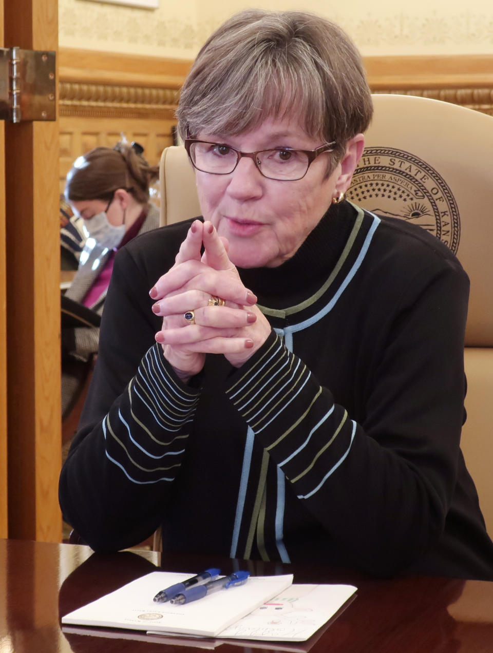 Kansas Gov. Laura Kelly answers questions during an Associated Press interview in her Statehouse office, Dec. 21, 2021, in Topeka, Kan. The Democratic governor has signed Republican legislation financially helping workers who refuse to get the COVID-19 vaccine despite federal mandates as she appeals to moderate GOP and GOP-leaning independent voters in her race for reelection. (AP Photo/John Hanna)