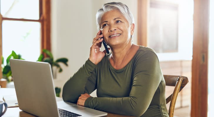 A senior calling a financial advisor to review her retirement plan.