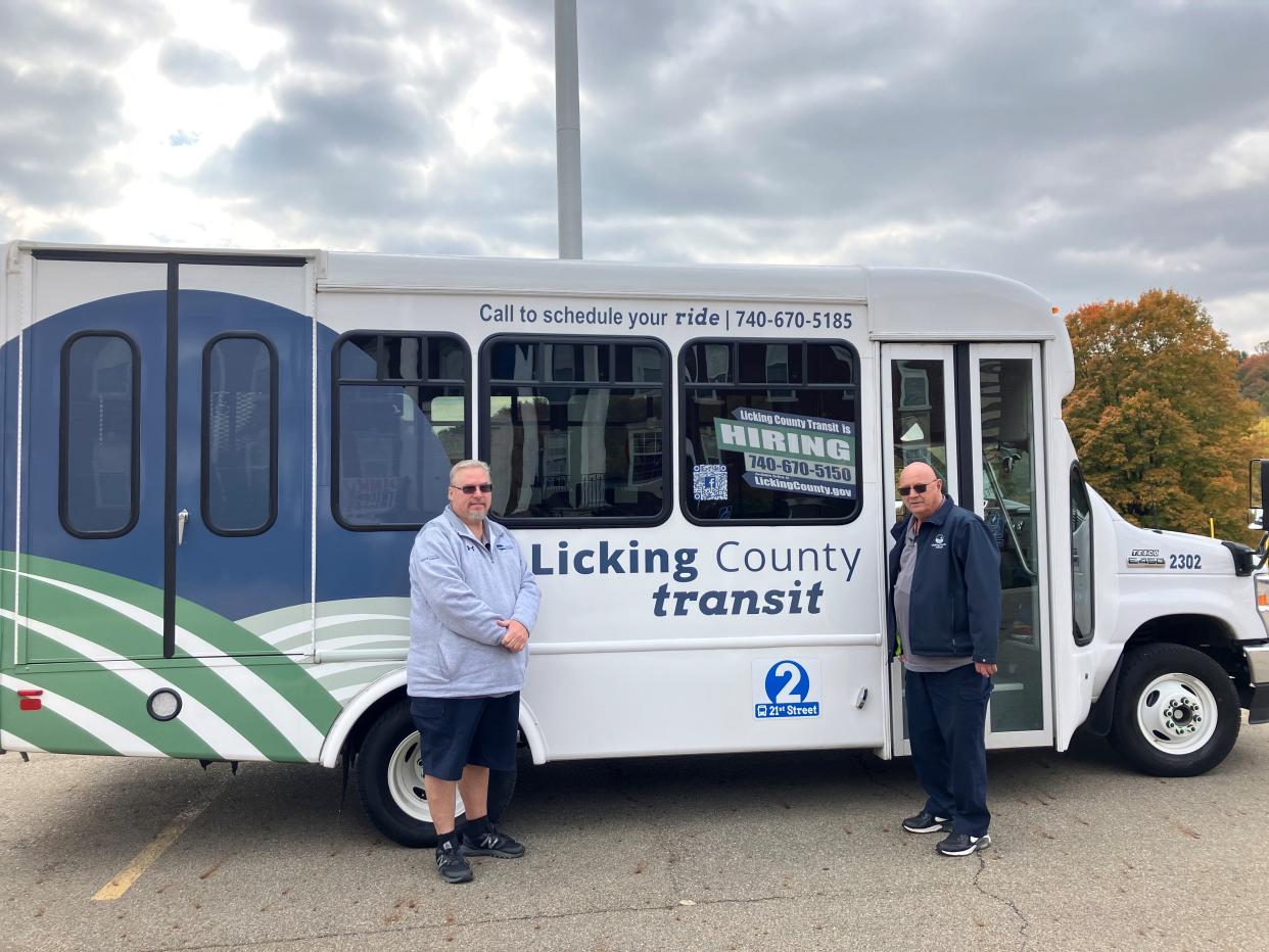 Licking County Transit drivers Roy Graves (left) and Don Swonger at a transit bus at the Licking County Health Department.