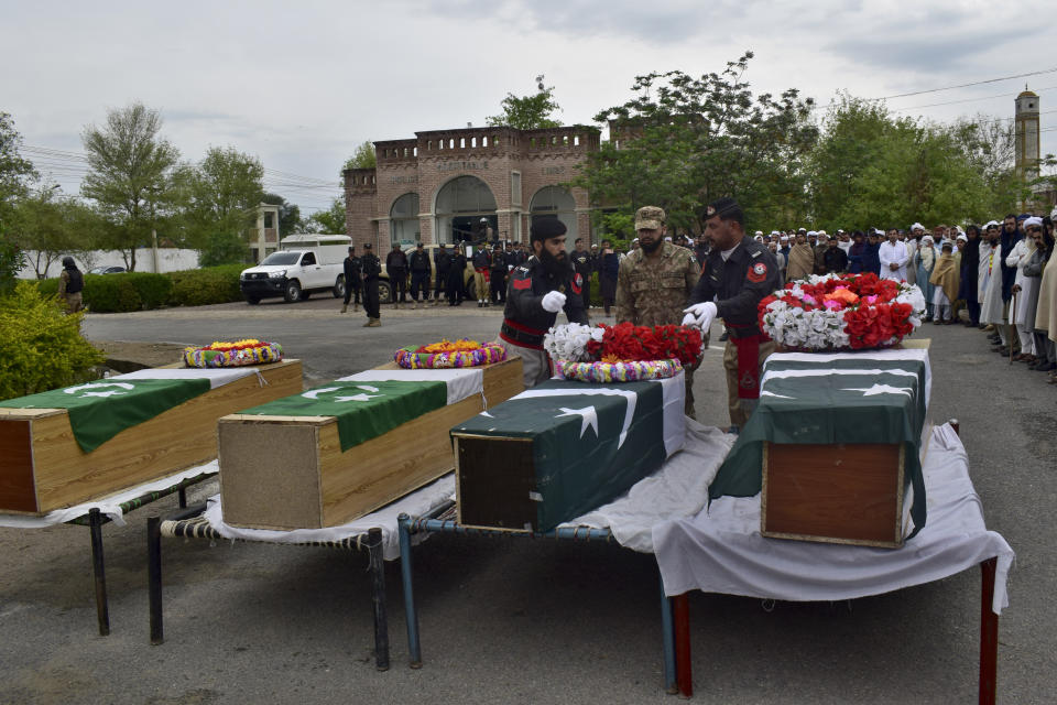 Security officials and others attend funeral prayer of police officer, who was killed in the bomb blast, in Lake Mart, a Pakistani town of Khyber Pakhtunkhwa province bordering Afghanistan, Thursday, March 30, 2023. Taliban militants in a pair of attacks killed four police officers by targeting a police vehicle with a roadside bomb and wounded six in an attack on a police station in northwest Pakistan early Thursday, (AP Photo/G.A. Marwat)