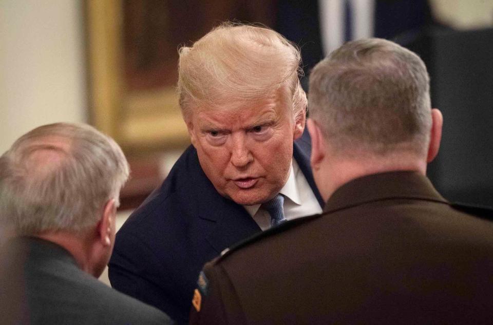 President Donald Trump reaches out to speak with Sen. Lindsey Graham (R-SC), left, and Gen. Mark Milley, chairman of the Joint Chiefs of Staff, right, following the presentation.
