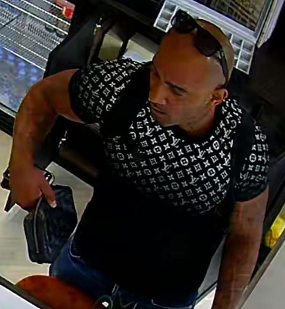 A man is seen having watches loaded into his rucksack (Metropolitan Police)