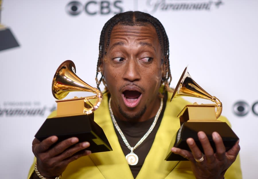 Lecrae poses in the press room with the awards for best contemporary christian music performance/song for “Your Power” and best contemporary christian music album for “Church Clothes 4” during the 66th annual Grammy Awards on Sunday, Feb. 4, 2024, in Los Angeles. (Photo by Richard Shotwell/Invision/AP)