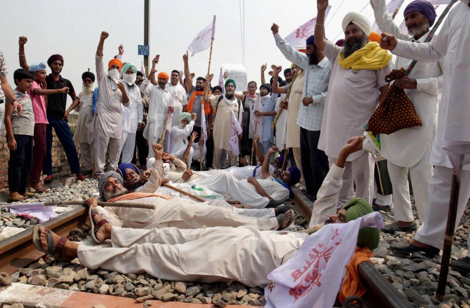 Farmers in Amritsar block a railway track as they participate in Rail Roko Andolan during a protest against the farm bills passed in both Houses of Parliament. 