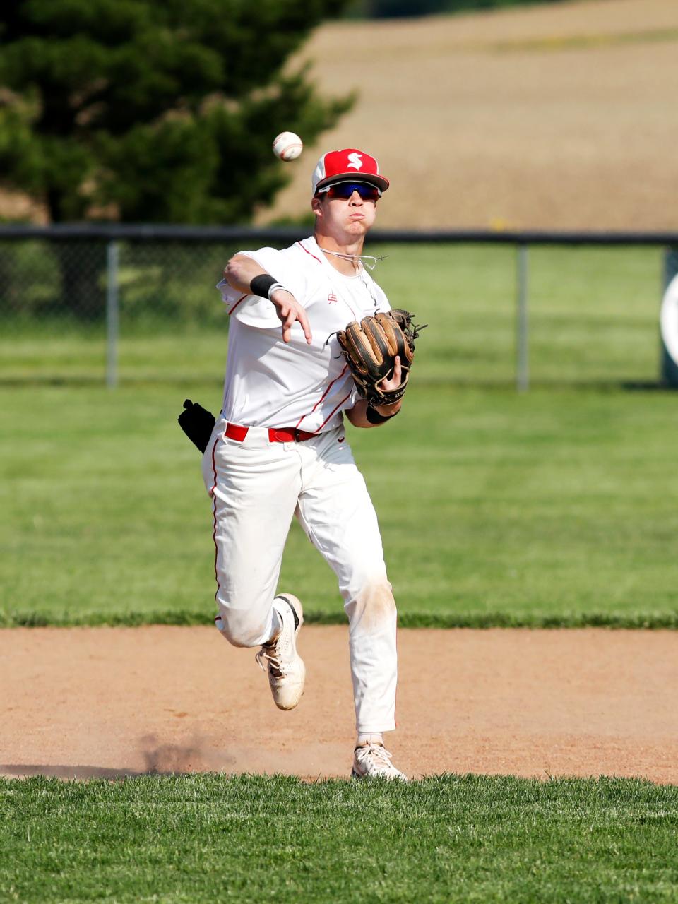 Sophomore shortstop A.J. Winders throws out a runner at first base during Sheridan's 8-1 loss to visiting Circleville in a Division II sectional final on May 17, 2023, in Thornville. Winders is entering his third year as a starter.