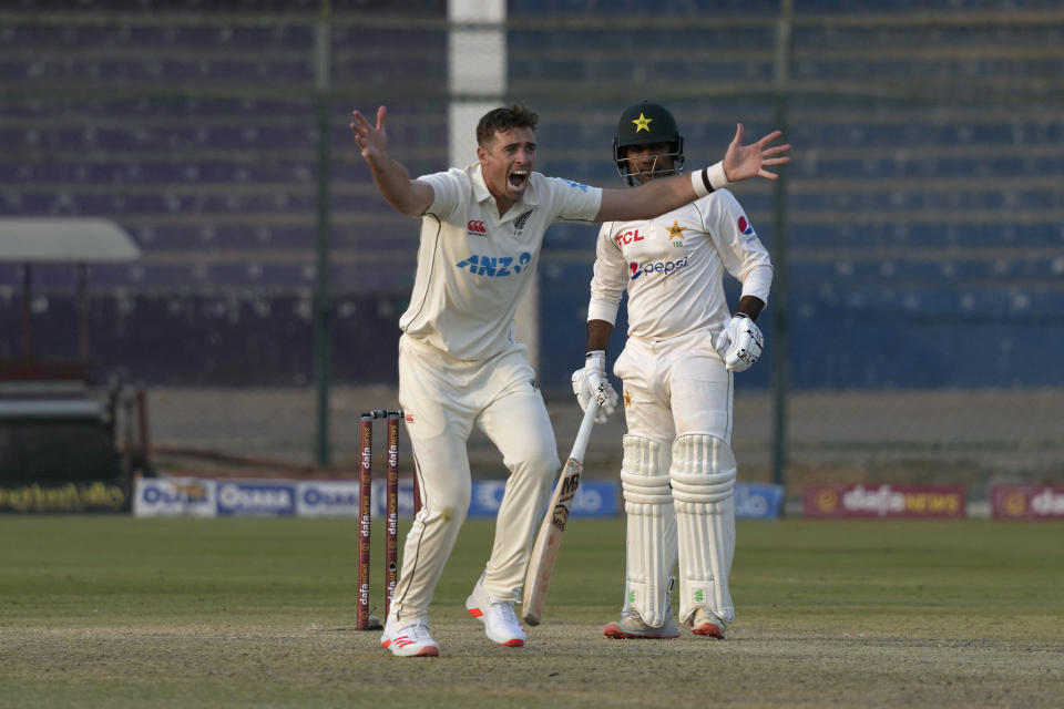 New Zealand's Tim Southee, left, appeals unsecessful LBW out of Pakistan Sarfraz Ahmed, right, during the first day of first test cricket match between Pakistan and New Zealand, in Karachi, Pakistan, Monday, Dec. 26, 2022. (AP Photo/Fareed Khan)