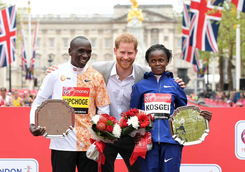 LONDON, ENGLAND - APRIL 28: Prince Harry, Duke of Sussex poses with Eliud Kipchoge (L), winner of the men's London marathon and Brigid Kosgei (R), winner of the women's London marathon during the medal ceremony at the Virgin London Marathon 2019 on April 28, 2019 in London, United Kingdom. (Photo by Karwai Tang/WireImage)