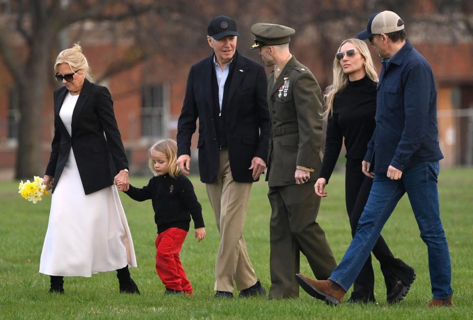 President Joe Biden talks to his Marine escort as he walks with grandson Beau and first lady Jill Biden as son Hunter Biden (R) walks with his wife Melissa, upon arrival at Fort McNair in Washington, DC, on March 31 (AFP via Getty Images)