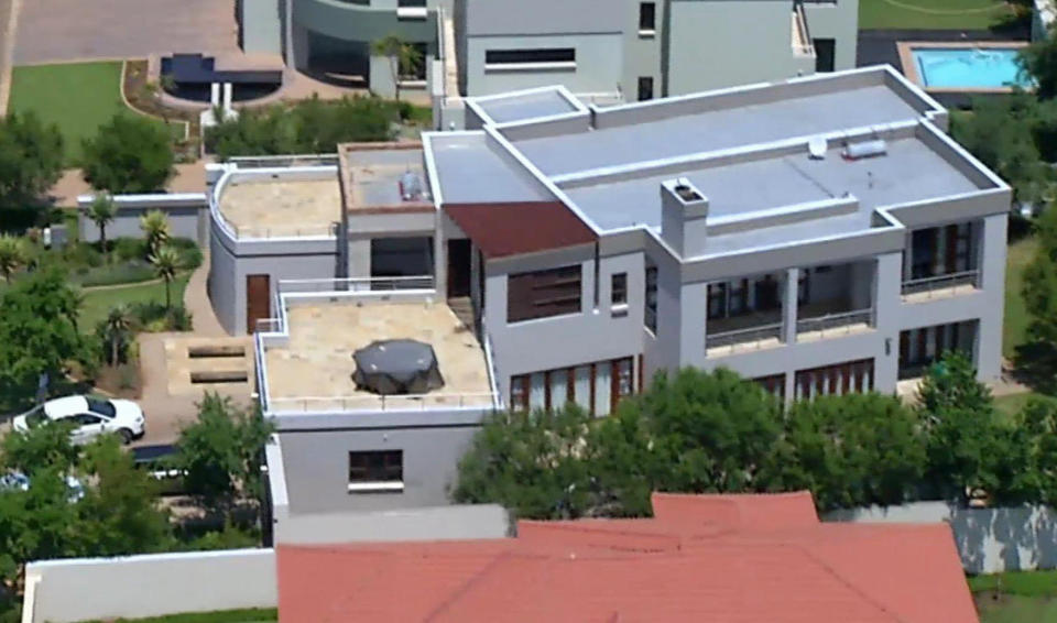 File - This file aerial image taken from video provided by VNS24/7 on Thursday, Feb. 14, 2013, shows the home of Olympic athlete Oscar Pistorius in a gated housing complex in Pretoria, South Africa. Oscar Pistorius is selling the house where Reeva Steenkamp was kiiled to raise money for his legal bills, and has still never returned to the upscale villa since the day he shot his girlfriend in an upstairs bathroom over a year ago, the athlete’s lawyer said Thursday. (AP Photo/VNS24/7-File)