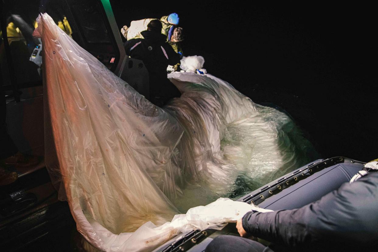 US Navy sailors Explosive Ordnance Disposal Group 2 recover a high-altitude surveillance balloon off the coast of Myrtle Beach, South Carolina, in the Atlantic Ocean on 6 February. (US NAVY/AFP via Getty Images)