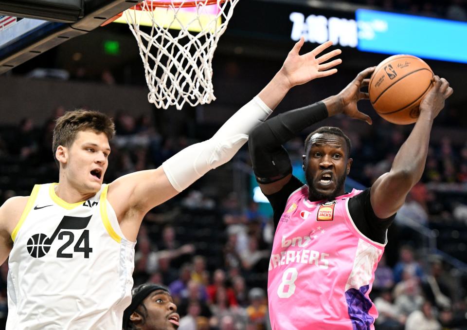 Utah Jazz center Walker Kessler isn’t able to reach against the Breakers’ Mangok Mathiang on Monday in Salt Lake City.