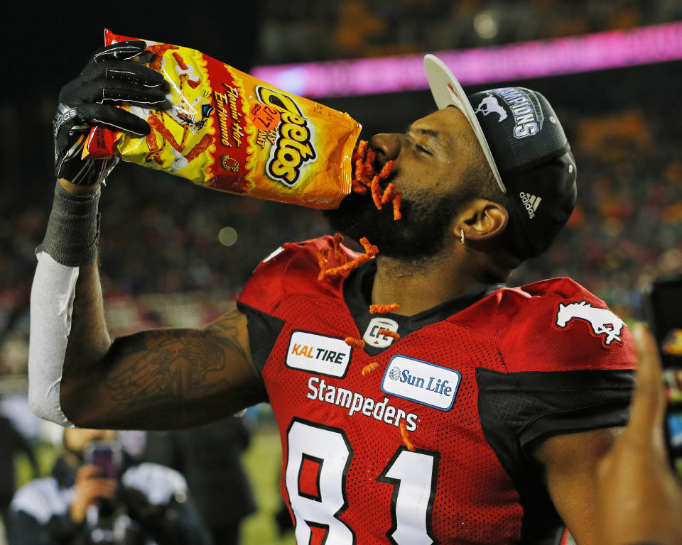 Nov 25, 2018; Edmonton, Alberta, CAN; Calgary Stampeders wide receiver Chris Matthews (81) celebrates winning the Grey Cup by having a bag a Cheetos during the 106th Grey Cup game at The Brick Field at Commonwealth Stadium. Mandatory Credit: Perry Nelson-USA TODAY Sports