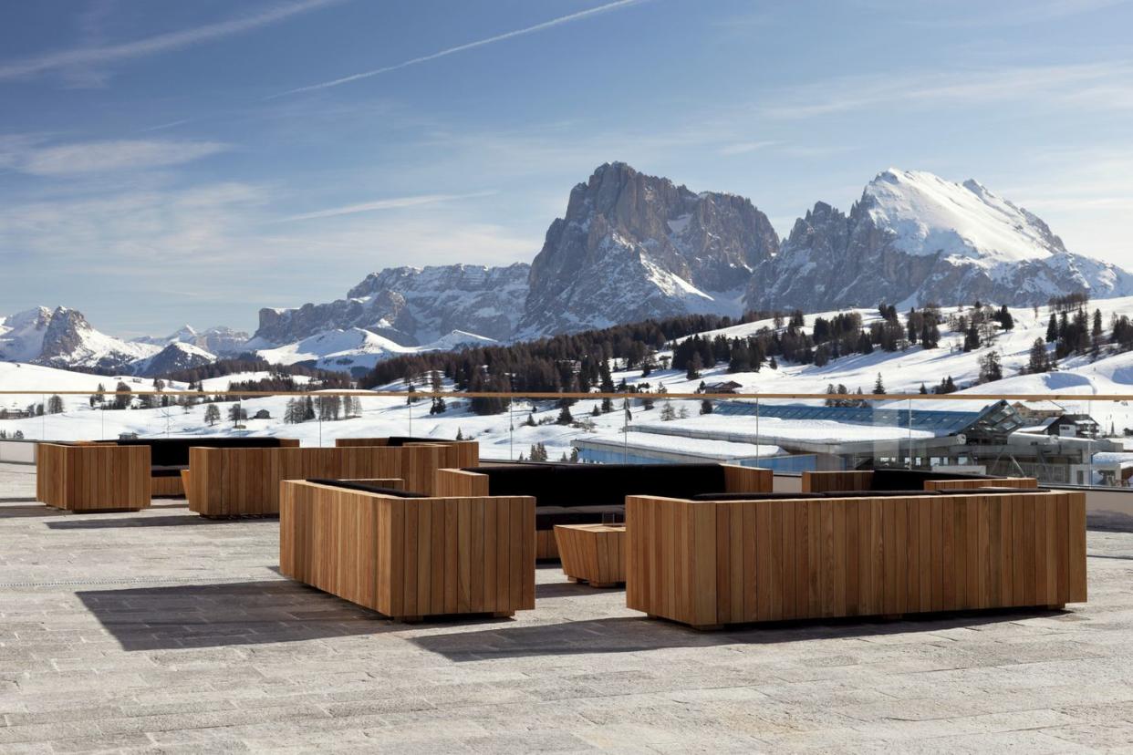 a wooden fence in front of a snowy town