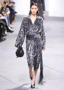 <p>Hadid continued her fashion month takeover at Michael Kors in a silver printed dress and statement hoops.</p>