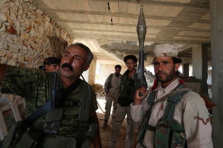 Fighters of the Syria Democratic Forces (SDF) stand inside a building near Manbij, in Aleppo Governorate, Syria, June 17, 2016. REUTERS/Rodi Said