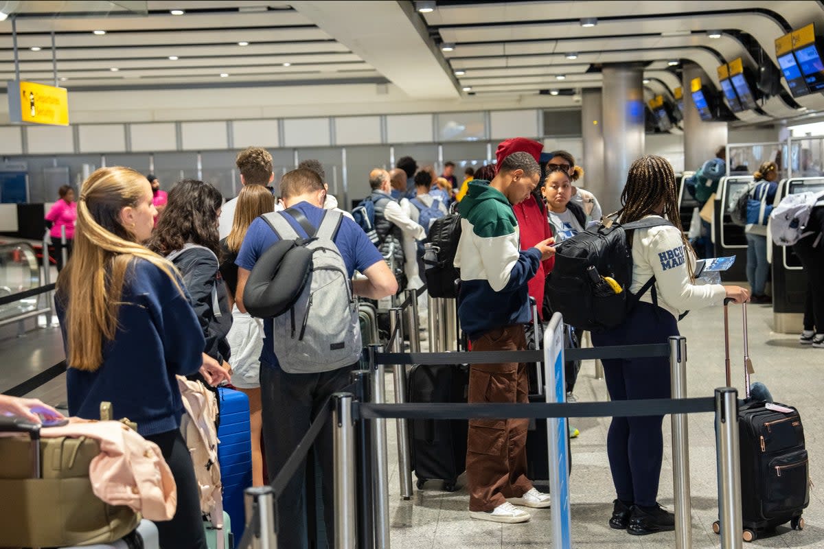 People queue to check in at Heathrow Airport on May 26, 2023 in London (Getty Images)