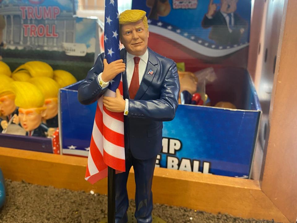 Trump hugging an American flag miniature.