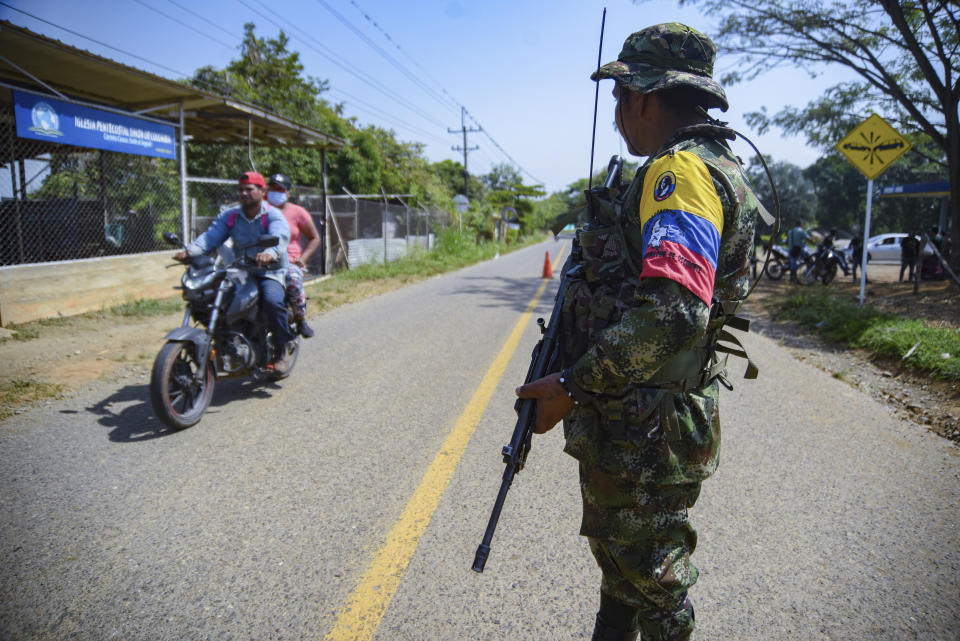 Un guerrillero del Estado Mayor Central (EMC) , la mayor disidencia de la extinta guerrilla Fuerzas Armadas Revolucionarias de Colombia (FARC), hace guardia en una carretera en Corinto, Colombia, el viernes 12 de abril de 2024, el día después de que un coche bomba explotara en la cercana ciudad de Miranda. El presidente Gustavo Petro señaló como posible perpetrador del ataque al EMC. (AP Foto/Edwin Rodríguez)