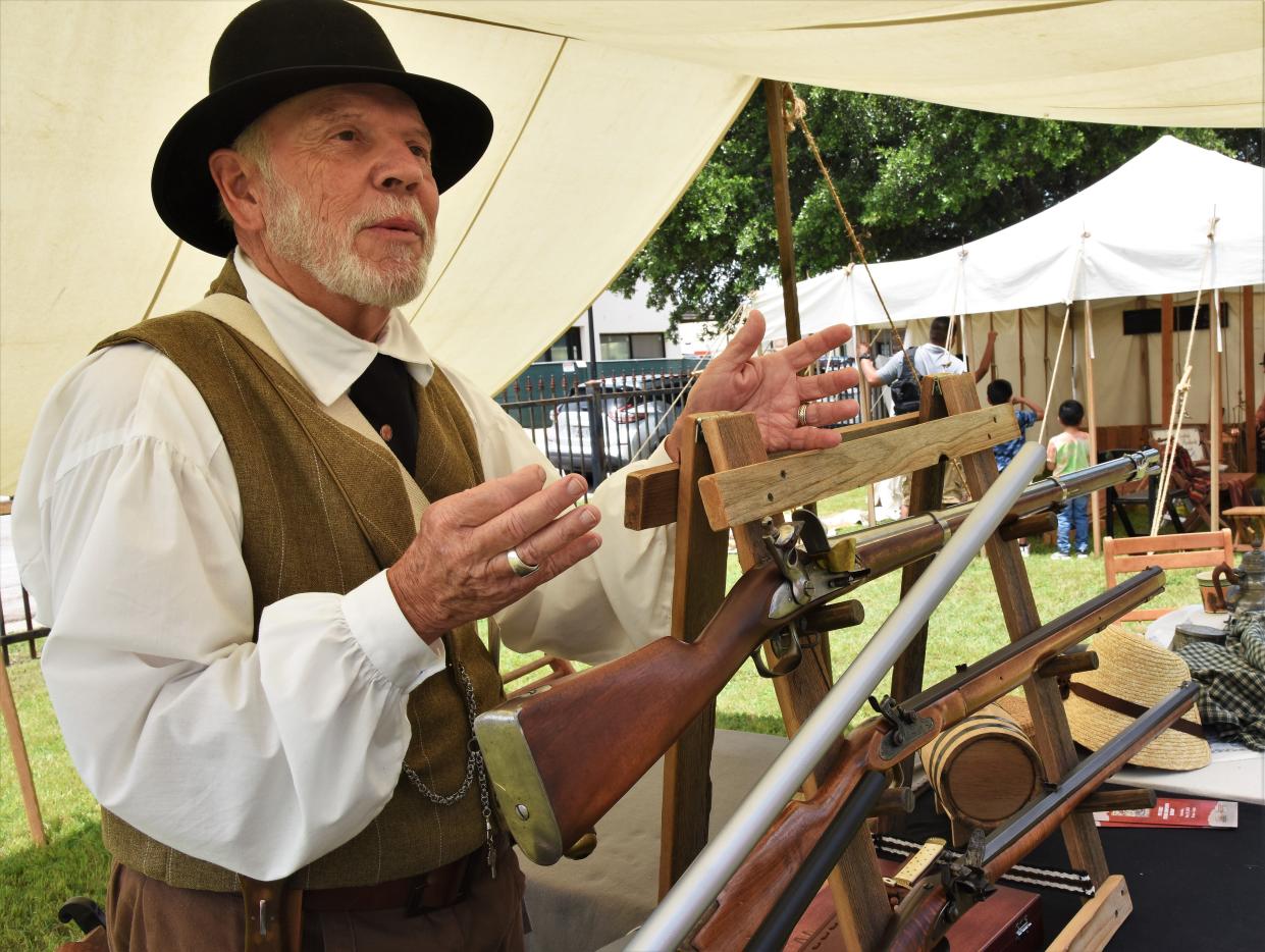 Joe Weathersby shows a display of pioneer-era muskets and rifles at last year's Yesterfest in downtown Bastrop, which returned after a five-year absence. The City Council approved $20,000 to again fund the event this year.