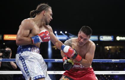 Keith Thurman (L) lands a punch to the face of Julio Diaz during their WBA interim welterweight title boxing match in April. (AP)