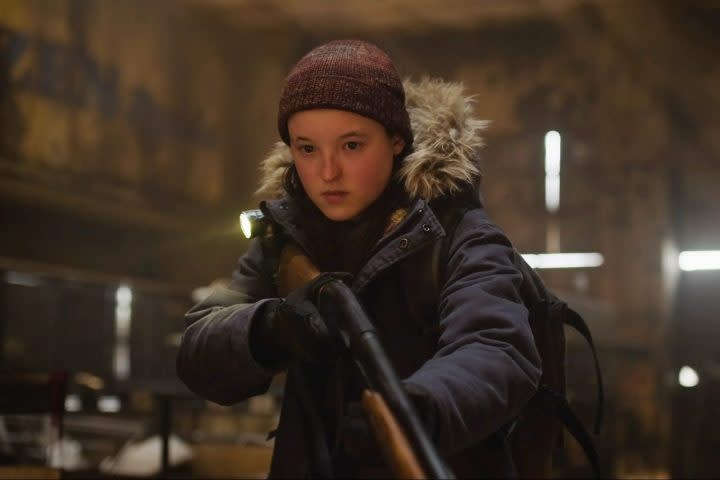 Bella Ramsey wields a shotgun in The Last of Us.