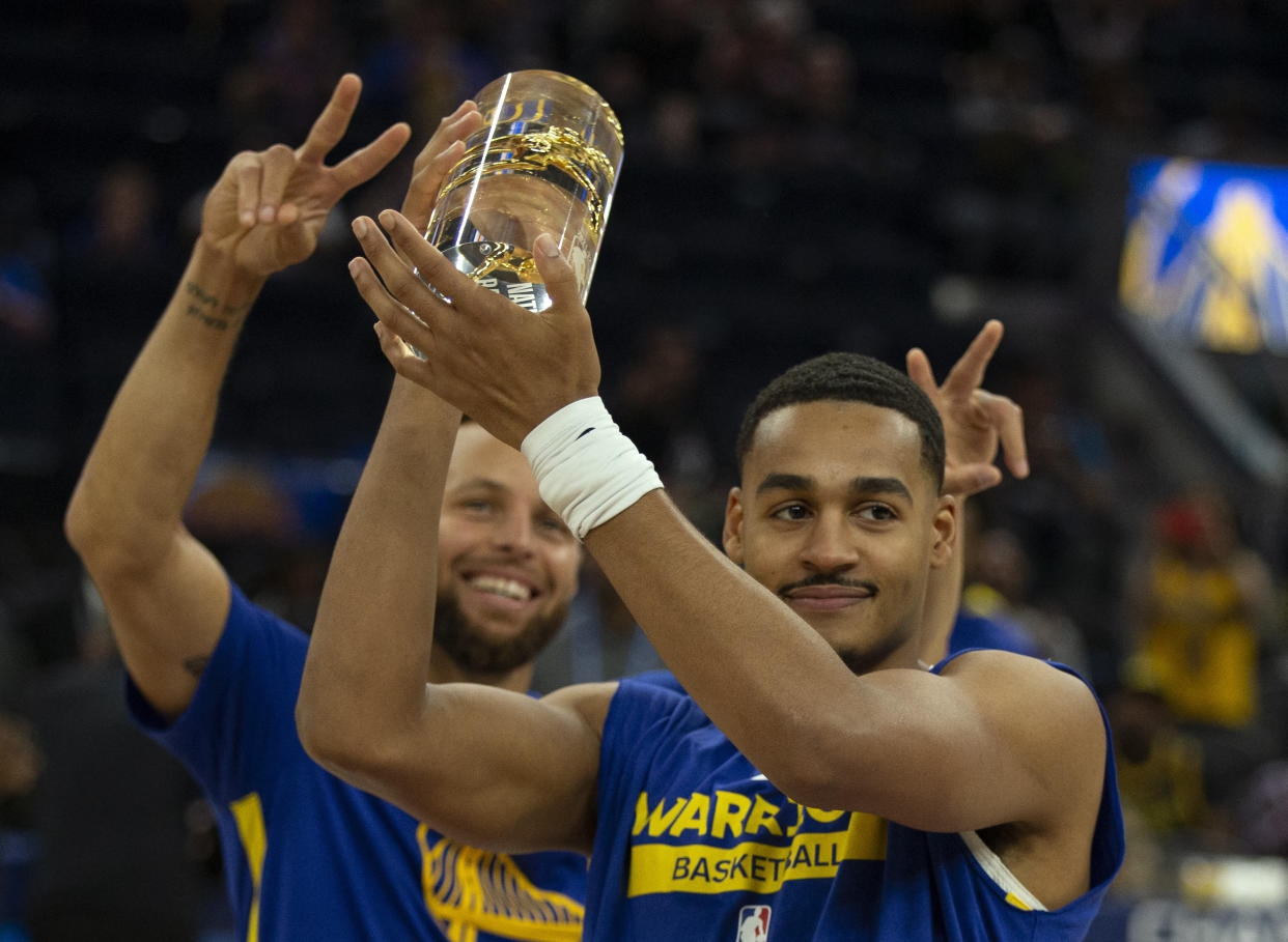 Oct 9, 2022; San Francisco, California, USA; Golden State Warriors guard Stephen Curry (left) congratulates teammate Jordan Poole on winning last seasonÕs NBA free throw percentage championship before a preseason game against the Los Angeles Lakers at Chase Center. Mandatory Credit: D. Ross Cameron-USA TODAY Sports