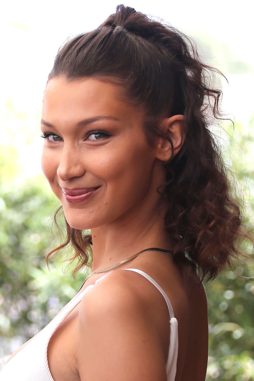 <p>If you find half-up styles to look a little too severe, try Bella Hadid's hair trick. Pull the pieces of hair just in front of your ears down, which softens the whole look,</p>