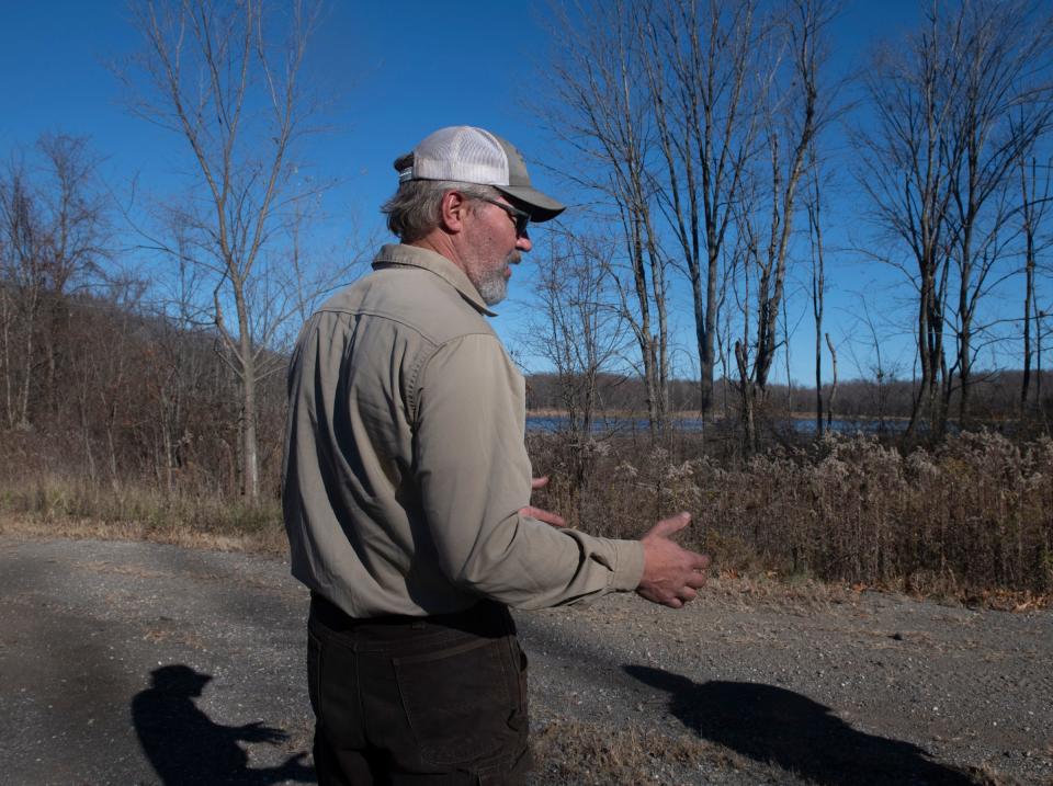 Portage Park District's natural areas steward, Bob Lange, on an access road to the lake, discusses the possible transaction. The Portage Park District has asked Ravenna to sell Crystal Lake, located in Rootstown, to the park district.