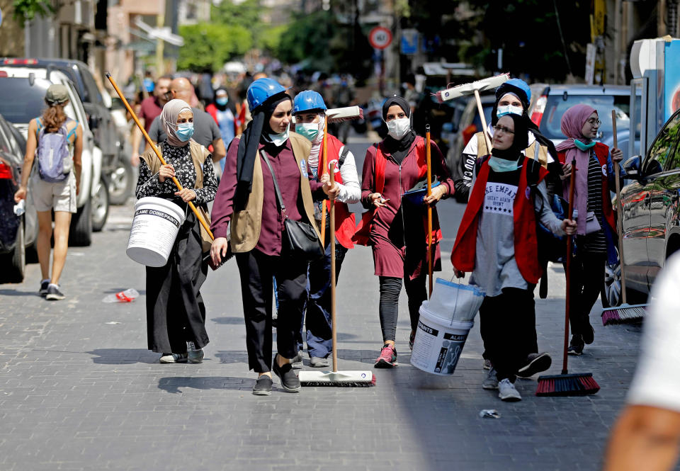 Image: Volunteers set out to clean Beirut's devastated Gemmayzeh neighborhood on Tuesday. (Joseph Eid / AFP - Getty Images)