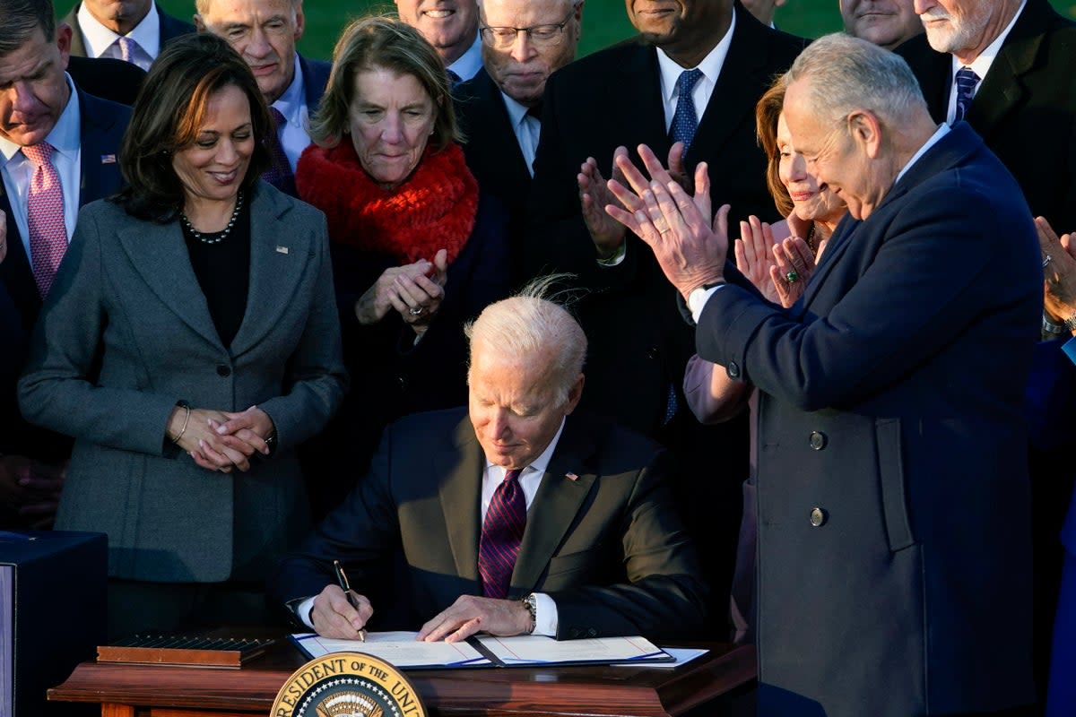 President Joe Biden signs the $1.2 trillion bipartisan infrastructure bill into law during a ceremony on the South Lawn of the White House in Washington, Nov. 15, 2021 (Associated Press)