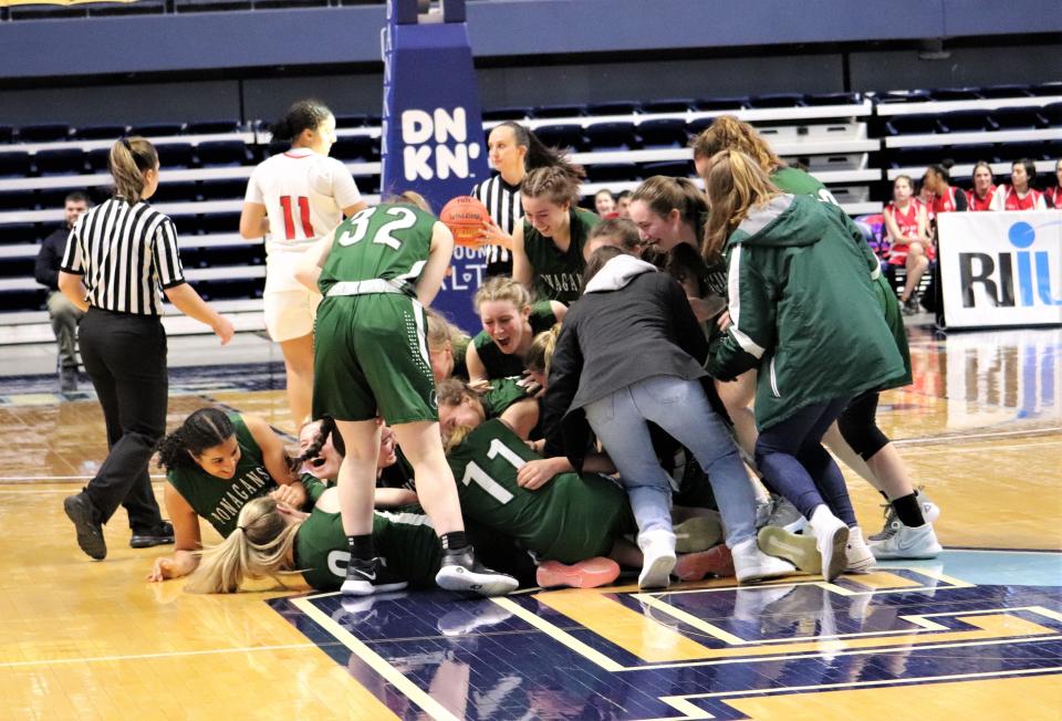 Members of the Ponaganset girls basketball team mob each other after defeating Juanita Sanchez, 58-51, for the RIIL state title