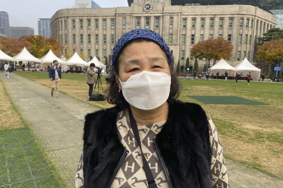 Lee Gye-bun speaks during an interview at a joint memorial altar for victims at Seoul Square in Seoul, South Korea, Tuesday, Nov. 1, 2022. The Halloween party crush in Seoul has caused an outpouring of public sympathy toward the 150 dead, but there's also a strong level of embarrassment and anger from citizens toward the country that they say still ignores safety and regulatory issues. (AP Photo/Hyung-Jin Kim)