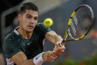 Spain's Carlos Alcaraz returns the ball against Nikoloz Basilashvili, of Georgia, during their match at the Mutua Madrid Open tennis tournament in Madrid, Spain, Tuesday, May 3, 2022. (AP Photo/Manu Fernandez)