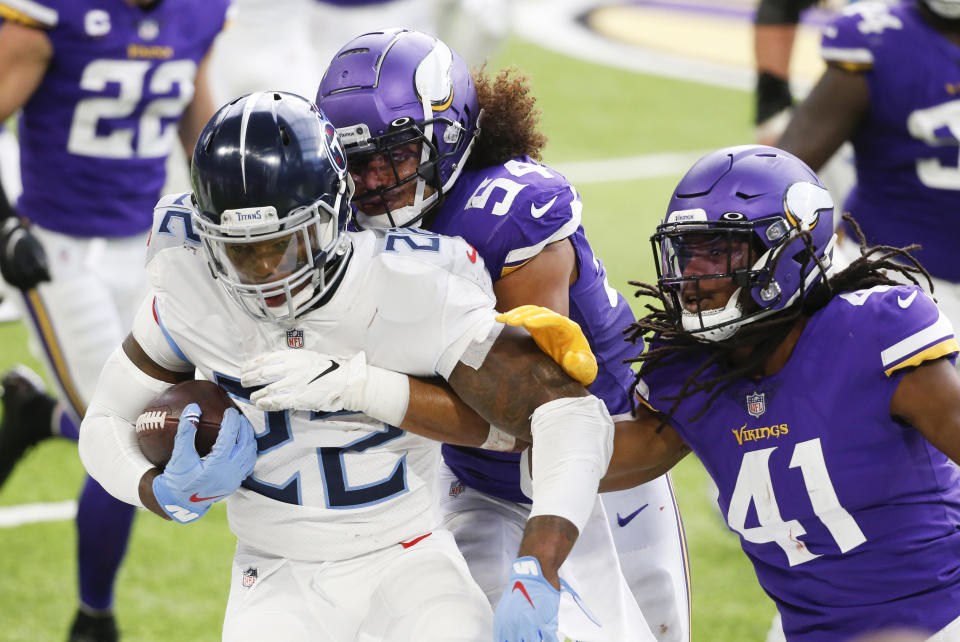 Tennessee Titans running back Derrick Henry (22) is tackled by Minnesota Vikings middle linebacker Eric Kendricks (54) and free safety Anthony Harris (41) during the first half of an NFL football game, Sunday, Sept. 27, 2020, in Minneapolis. (AP Photo/Bruce Kluckhohn)