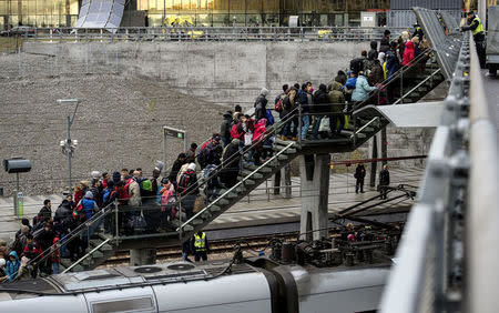 Police organize a line of refugees on a stairway leading up to trains arriving from Denmark at the Hyllie train station outside Malmo, Sweden, November 19, 2015. REUTERS/Johan Nilsson/TT News Agency/File Photo