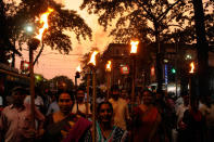 <p>Marchers in Kolkata, India hold torches during a rally to protest against violence in West Bengal Panchayat polls from Esplnade to Moulali crossing on May 4, 2018. (Photo from Samir Jana/Hindustan Times via Getty Images) </p>