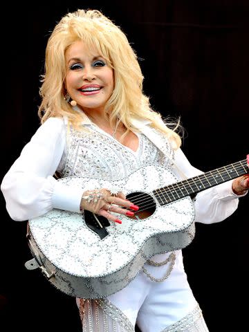 <p>Shirlaine Forrest/WireImage</p> Dolly Parton performs during the 2014 Glastonbury Festival.