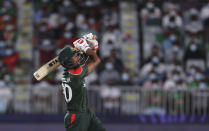 Bangladesh's captain Mohammad Mahmudullah watches on his midair shot during the Cricket Twenty20 World Cup first round match between Bangladesh and Scotland in Muscat, Oman, Sunday, Oct. 17, 2021. (AP Photo/Kamran Jebreili)