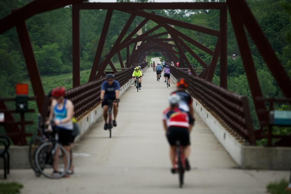 Cyclists ride across the High Trestle Trail Bridge during the annual Pigtails ride along the High Trestle trail on Saturday, May 22, 2021, in Madrid, IA. 