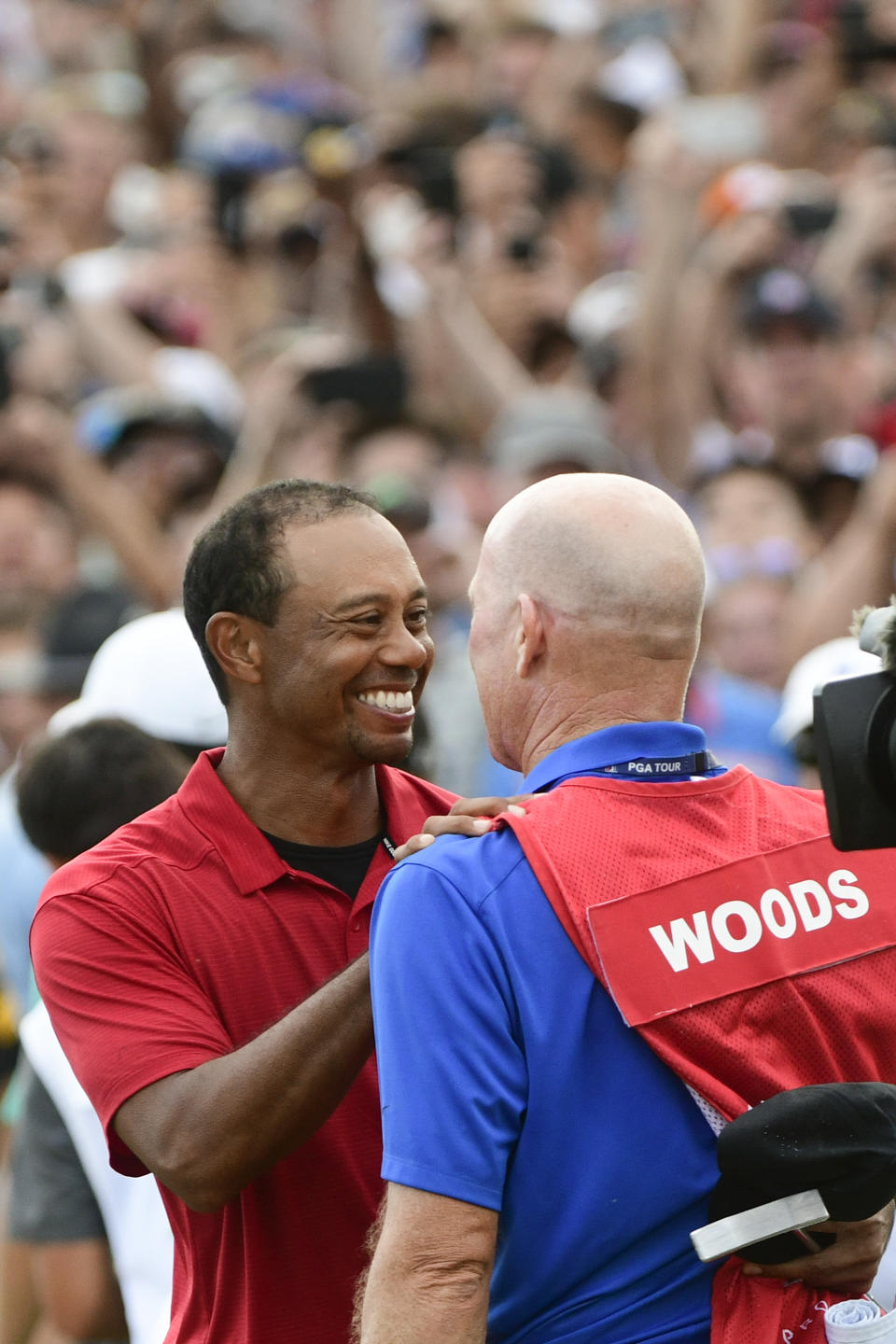 Tiger Woods and caddie Joe LaCava, right, congratulate each other after winning the Tour Championship golf tournament Sunday, Sept. 23, 2018, in Atlanta. (AP Photo/John Amis)