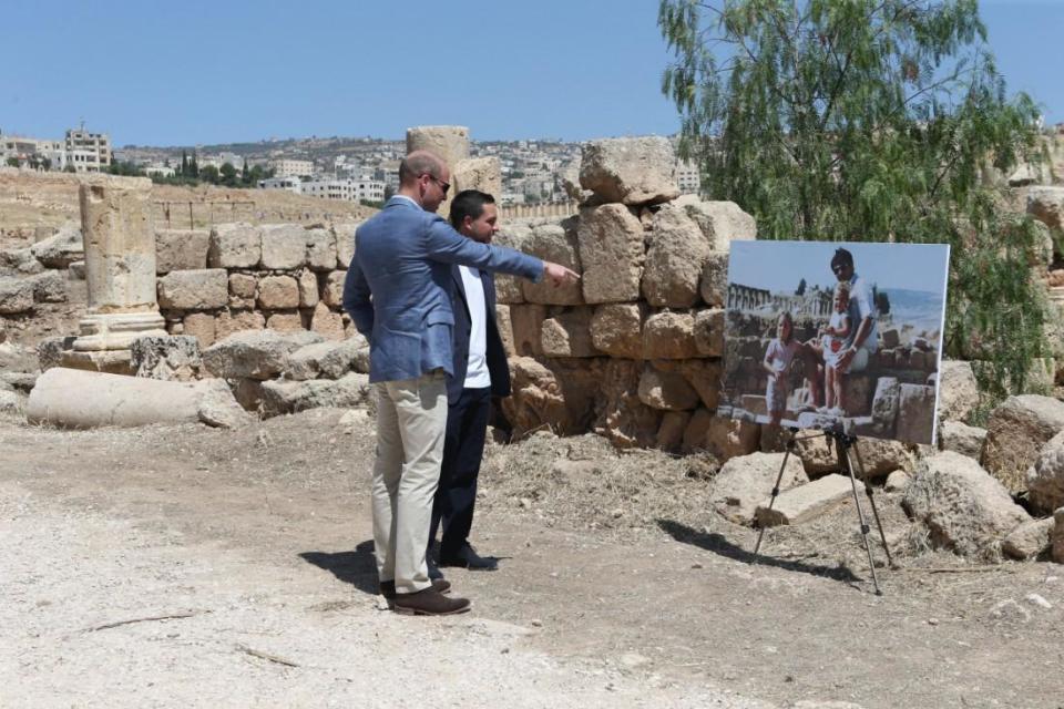 Jordan: William and Crown Prince Hussein of Jordan look at a photo of the Duchess when she was photographed with her family at the same spot (PA)