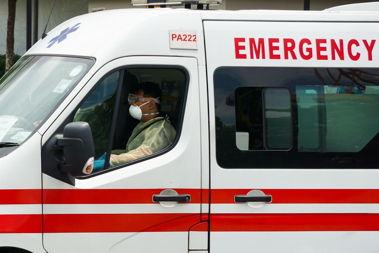 An ambulance carrying staff in protective clothing leaves the National Centre for Infectious Diseases, where patients suffering from the COVID-19 novel coronavirus are being cared for, in Singapore on April 3, 2020. (Photo by Roslan RAHMAN / AFP) (Photo by ROSLAN RAHMAN/AFP via Getty Images)